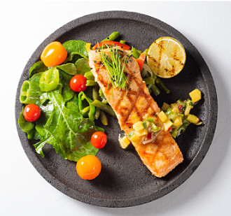 A healthy version of Blackened Salmon with Mango Salsa and Avocado plated ready to eat.